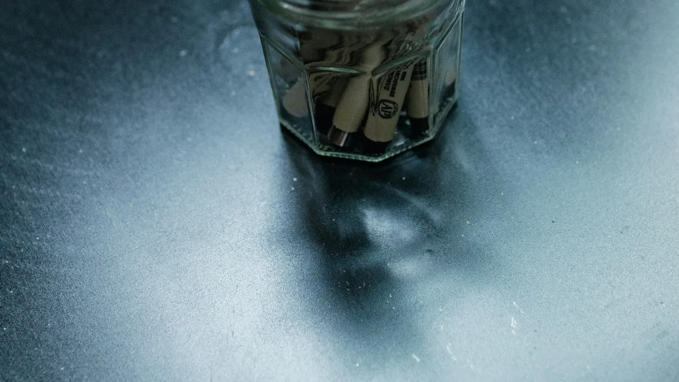 a jar of match sticks on a table