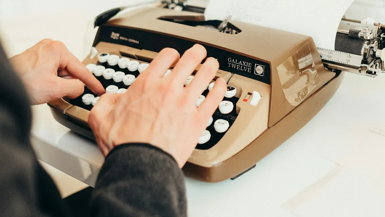 a man typing on a typewriter